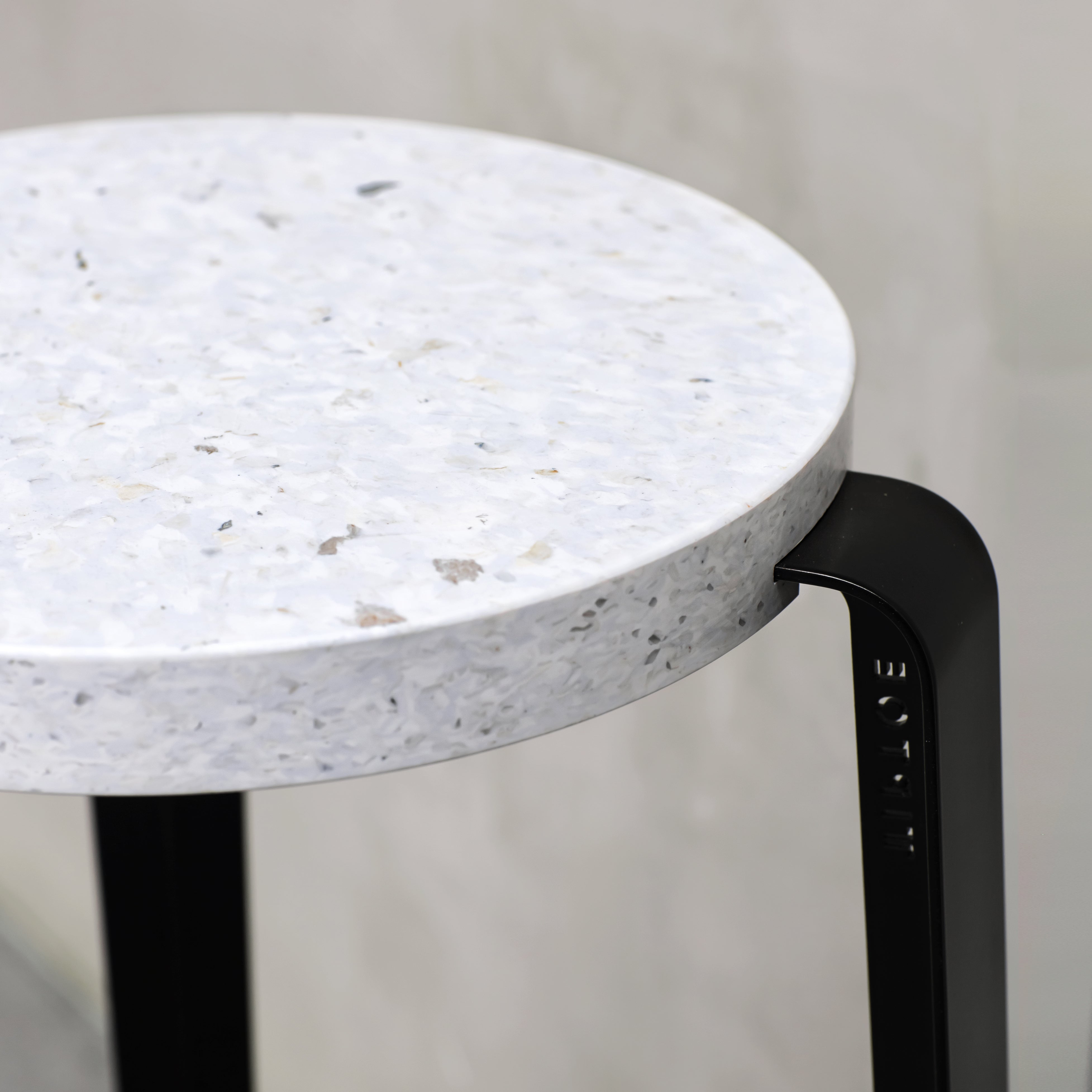 Hocker Lou Venezia von Tiptoe mit recycelter Sitzfläche und pulverbeschichteten Beinen in graphite black bei Frau Rabe im Concept Store Die Halle